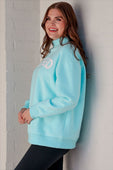Light blue soft fleece blessed mock neck pullover with white lettering across chest fits size comfortably