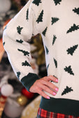 Cream-colored christmas forest knit sweater with dark green pine tree pattern and ribbed cuffs and hem
