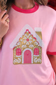 Pink ringer tee with a foil gingerbread house appliqué in glittery gold and pink with white snowflake details
