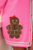 Brown gingerbread girl appliqué with red bow and silver sequins on bright pink knit girl long cardigan