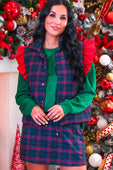Navy christmas plaid puffer vest with green and red plaid ruffle shoulder details worn over matching skirt