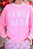 Pink santa baby jacquard knit sweater with white lettering and striped cuffs in a festive holiday design