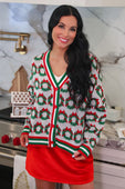 Festive white red and green ribbon wreath knit cardigan with repeating wreath pattern and red bows
