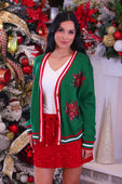 Green cardigan with red and white trim and sequin poinsettia embellishments perfect for festive wear sequin poinsettia cardigan