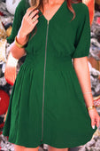 A vibrant emerald green tinsley zipper dress with short puffed sleeves and a smocked waist flare skirt