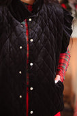 Black velvet quilted vest with silver buttons and ruffle shoulder details in a velvet finish