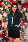 Emerald green velvet quilted vest with button closure and front pockets featuring a velvet finish